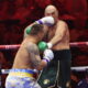 Tyson Fury dodging a punch from Oleksandr Usyk during their heavyweight boxing rematch.